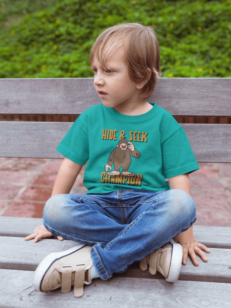 sad kid wearing a tshirt mockup sitting on a bench a17954 (teal)